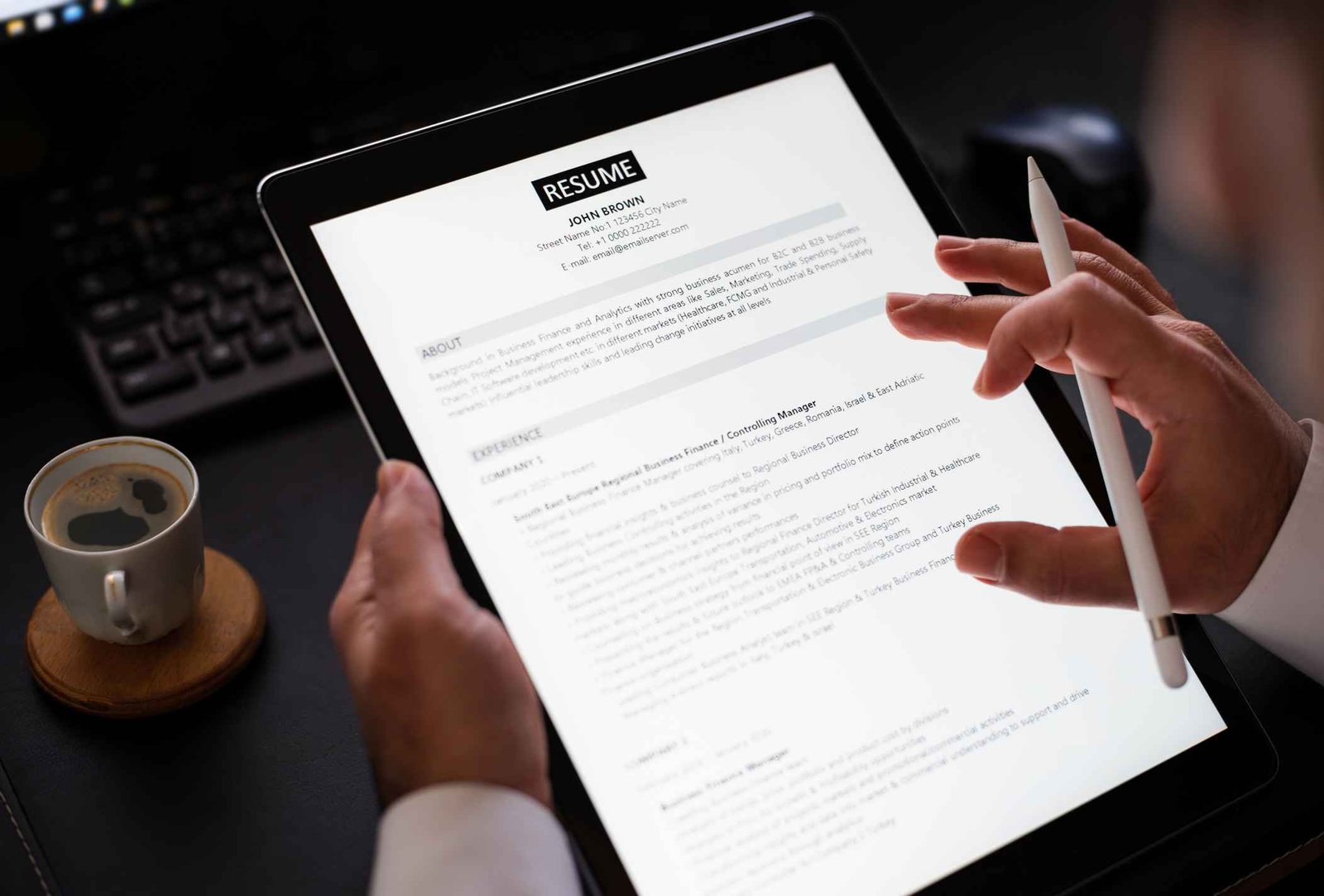 businessman-reading-a-resume-on-digital-tablet-help-with-job-searching