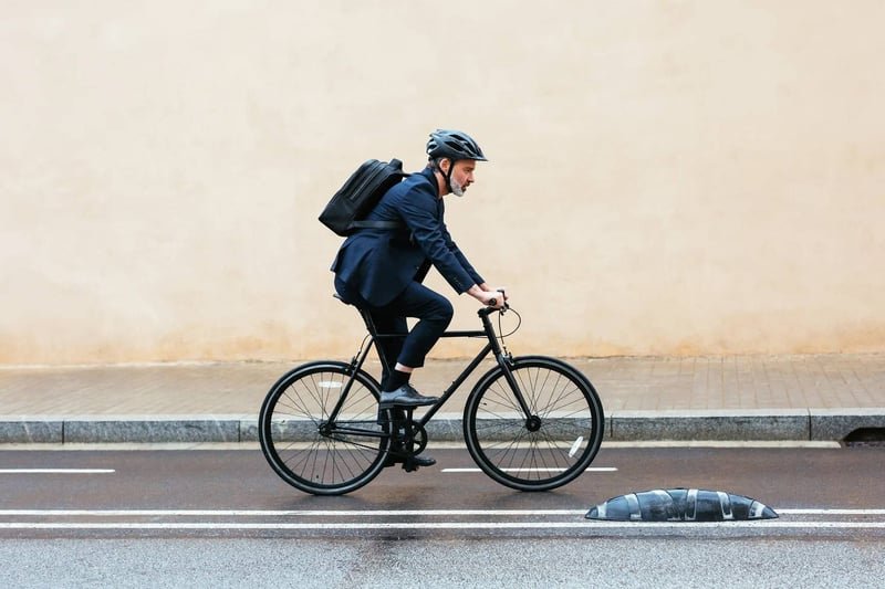 Grey-haired-businessman-riding-a-bike-to-work